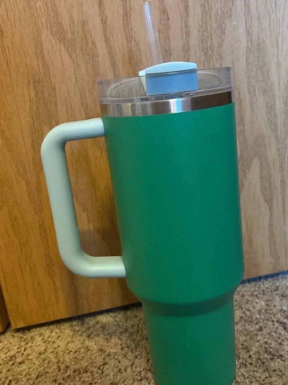 Stanley Green Tumbler with Light Blue Handle and Lid Accent